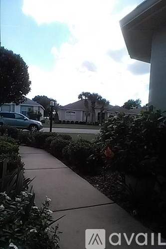 A house with a car parked in front of it.