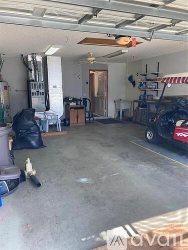 A garage with a car and some tools.
