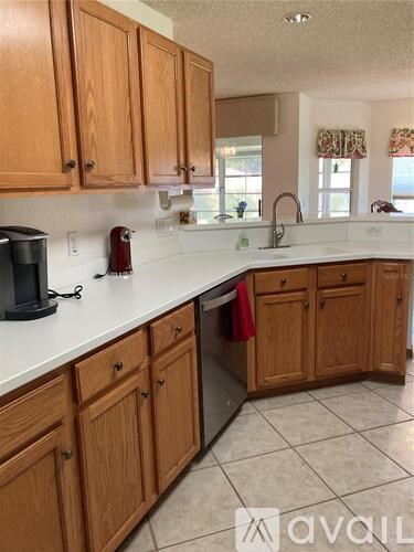 A kitchen with wooden cabinets and a white countertop.