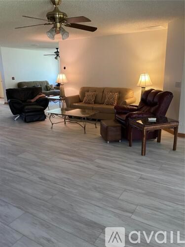A living room with a ceiling fan and a couch.