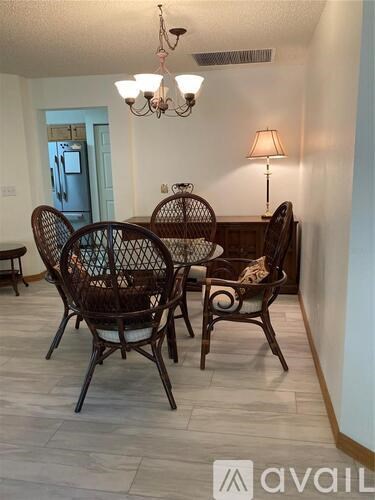 A dining room with a table set for four.