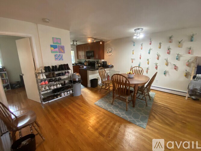 A kitchen with a dining table and chairs in the middle of the room.