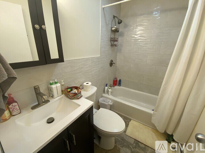 A bathroom with a white sink, toilet, and bathtub.