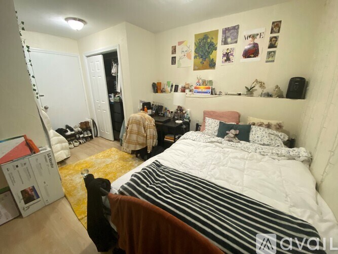 A bedroom with a bed, a chair, and a dresser.