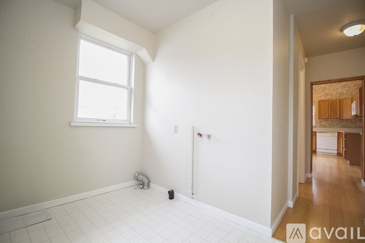 A room with a window and a door is available for rent.