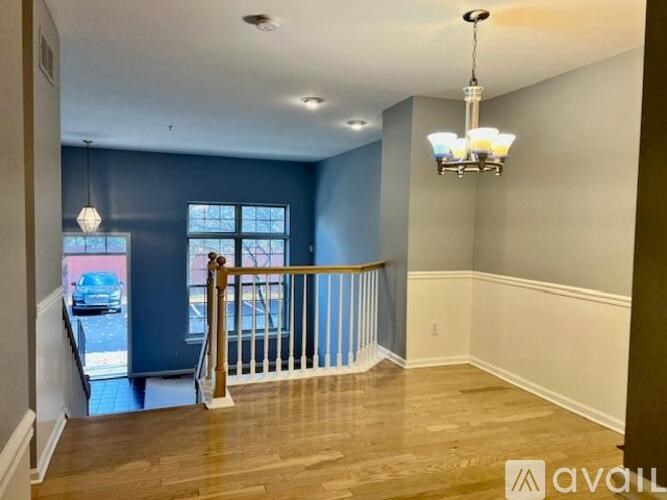 A room with a balcony and a chandelier.