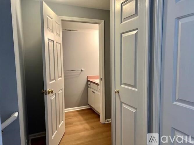 A hallway with a door on the left and a door on the right.