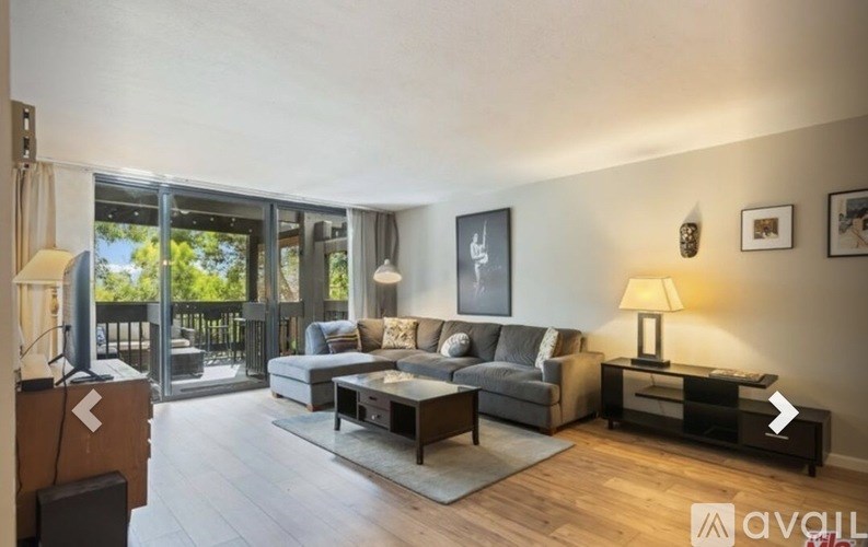 A living room with a grey couch and a coffee table.