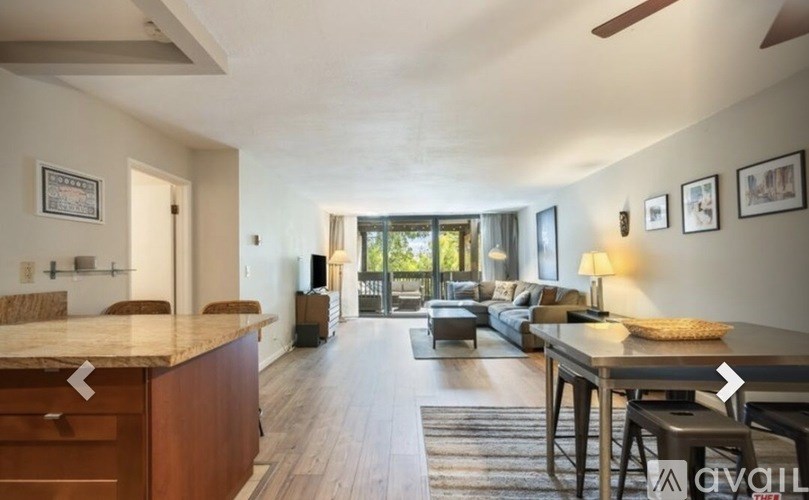 A modern kitchen with a dining table and chairs.