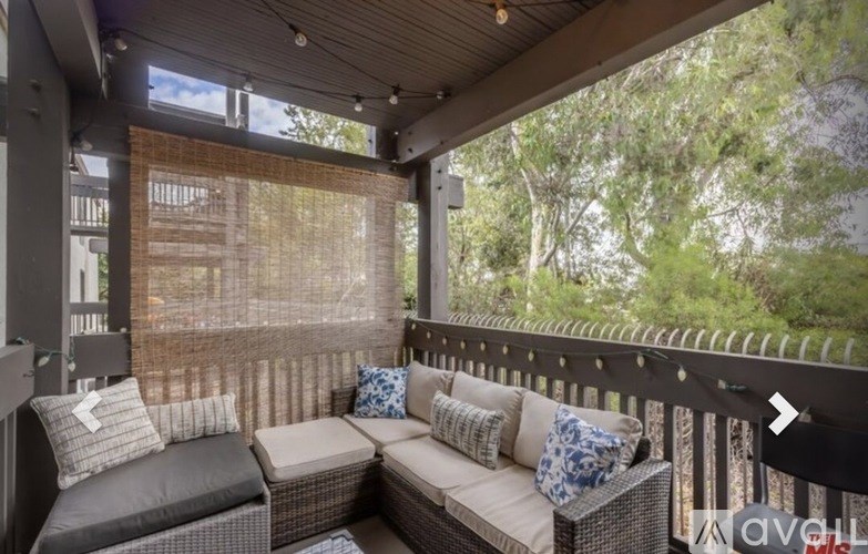 A patio with a couch and pillows is shown.