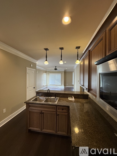 A kitchen with wooden cabinets and stainless steel appliances.