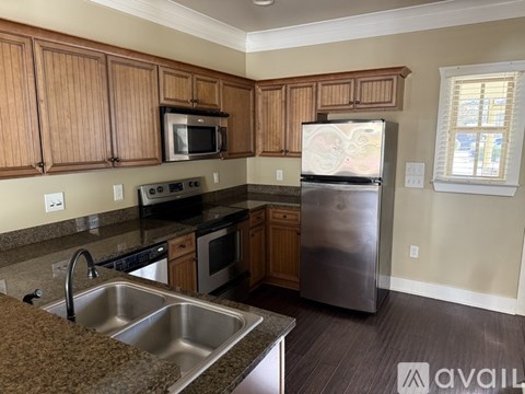 A kitchen with wooden cabinets and stainless steel appliances.