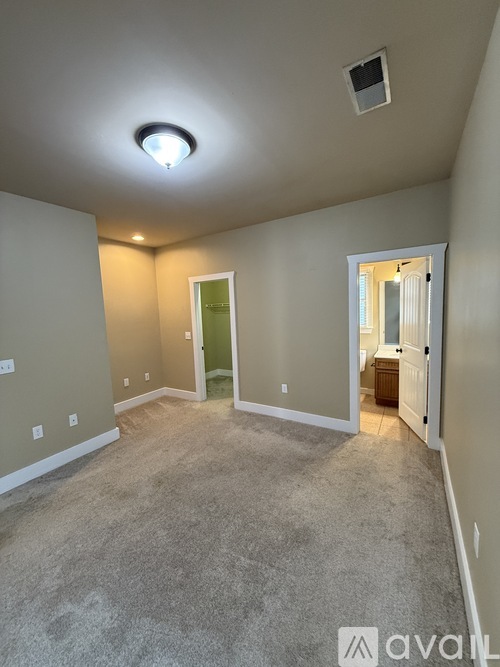 A room with wooden flooring and a ceiling fan.