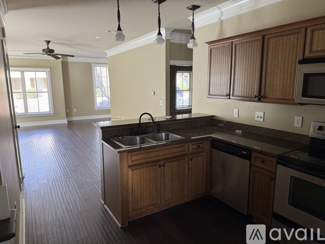 A kitchen with wooden cabinets and a sink.