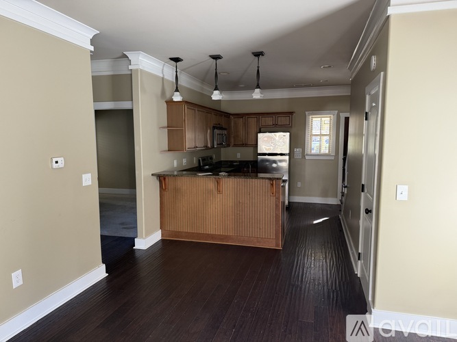 A kitchen with wooden cabinets and a black countertop.