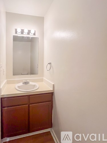 A bathroom with a sink and mirror.