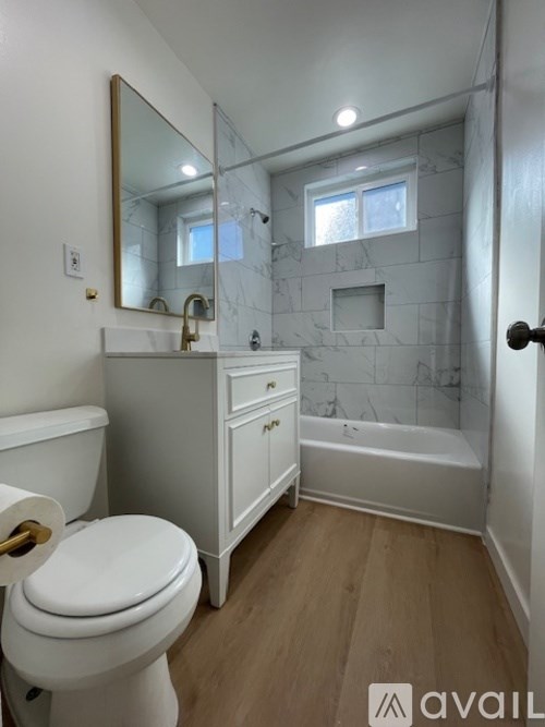 A bathroom with a toilet, sink, and bathtub.