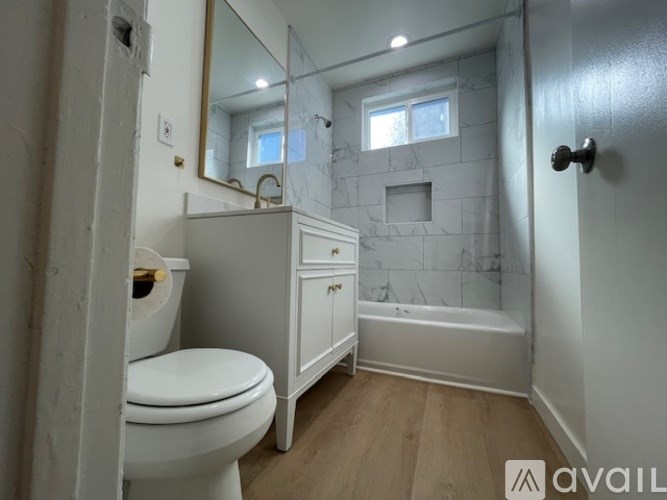 A bathroom with a toilet, a sink, and a bathtub.