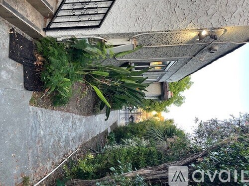 A wall with a planter under a vent.
