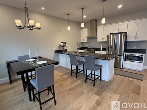 A modern kitchen with a dining table and chairs.