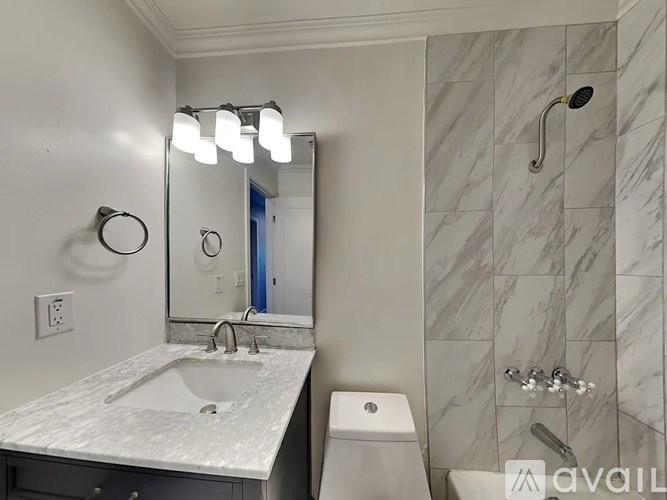A bathroom with a marble sink and toilet.