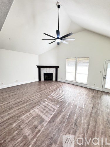 A room with a wooden floor and a ceiling fan.