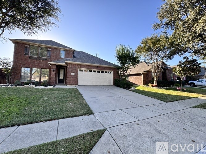 A house with a garage and a driveway in front of it.