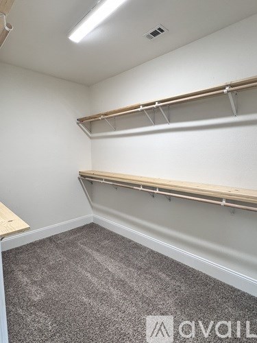 Empty room with grey carpet and white walls.