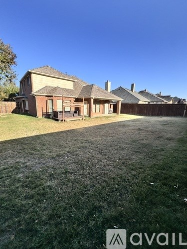 A house with a lawn in front of it.