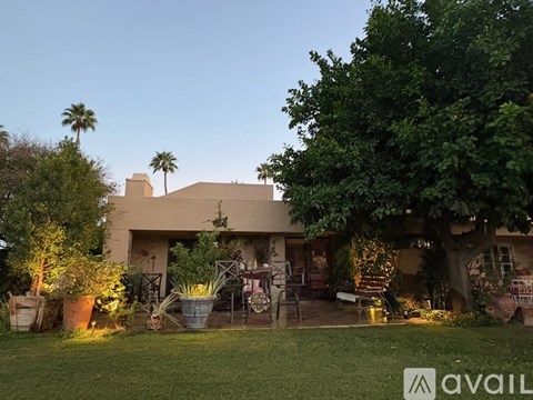 A house with a patio and trees in the background.