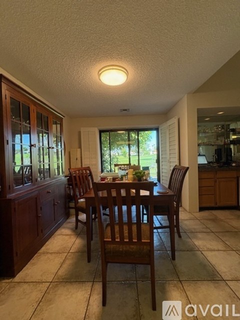 A dining room with a table set for four.