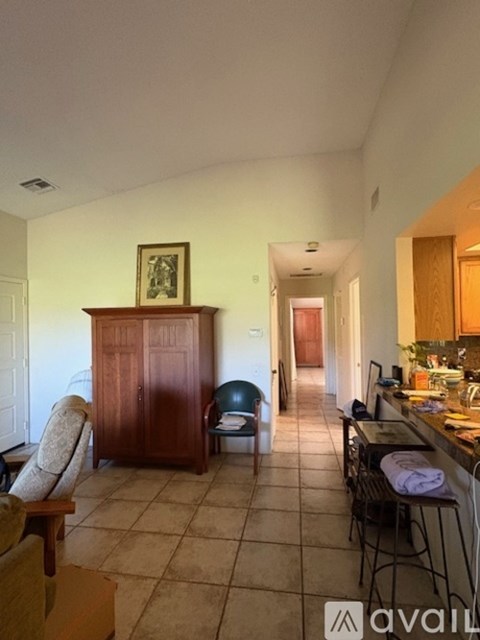 A kitchen area with a table and chairs.