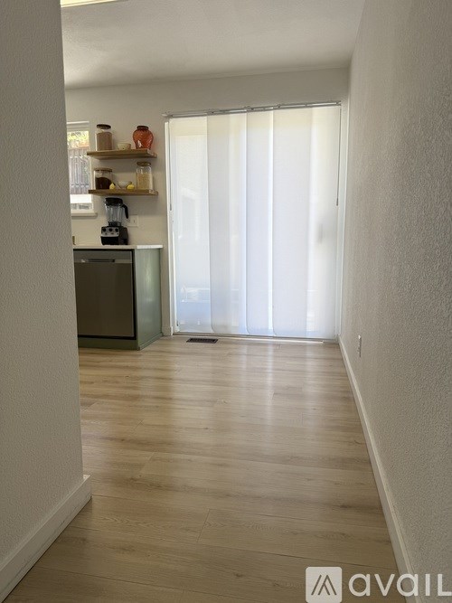 A kitchen area with a coffee machine on the counter.