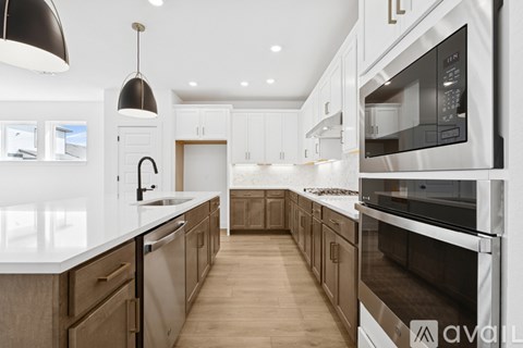 A modern kitchen with a white countertop and dark brown cabinets.