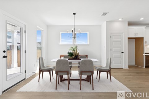 A modern dining room with a table set for four.
