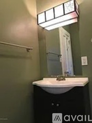 A bathroom with a sink and a mirror.