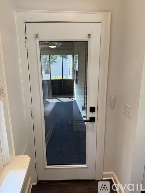 A white door with a glass window and a black handle.