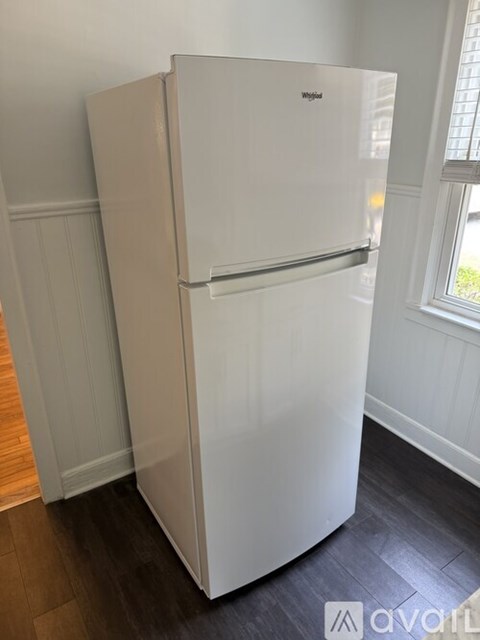 A white Whirlpool refrigerator in a kitchen.