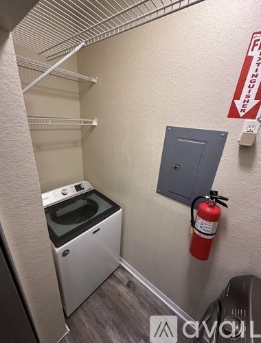 A small laundry room with a washer and dryer.