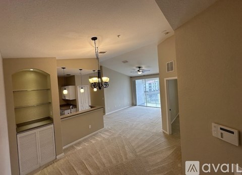 A spacious living room with a bar area and a view of the outside.