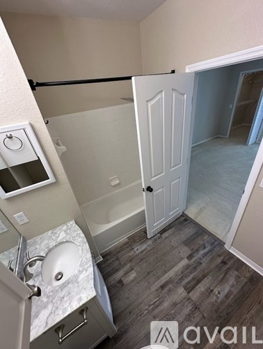 A bathroom with a toilet, sink, and bathtub.