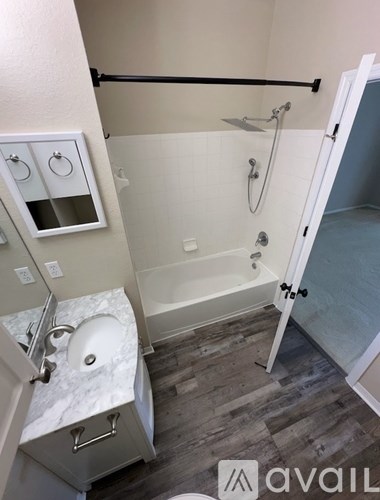 A bathroom with a toilet, sink, and bathtub.