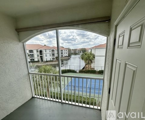 A balcony with a pool and apartment buildings in the background.