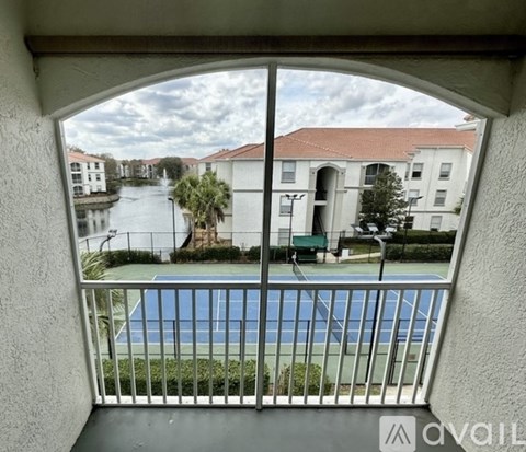 A balcony with a pool table and a view of a canal and buildings.
