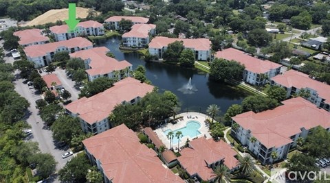 A bird's eye view of a resort with a green arrow pointing to a specific building.