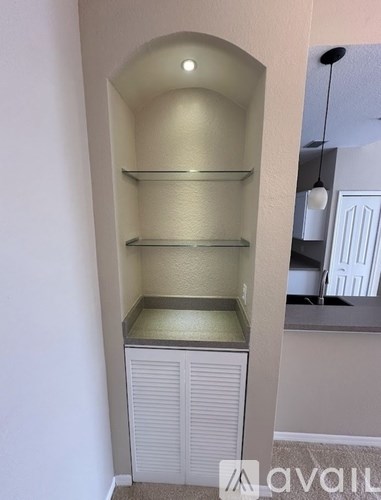 A white pantry with a shelf and a cabinet.