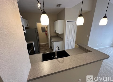 A kitchen with a sink and cabinets.