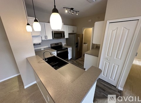 A kitchen with a black stove top oven and a black microwave above the stove.