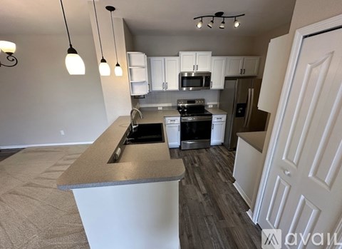 A kitchen with a white countertop and a stove top oven.