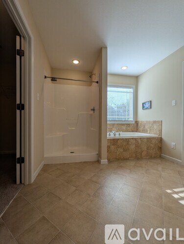 A bathroom with a tub and a walk-in shower.